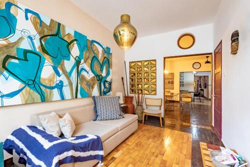 a living room with a couch and a painting on the wall at Hotel Casa do Bispo in Manaus
