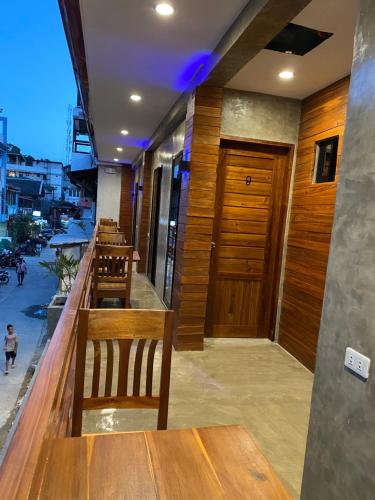 a bar with wooden benches and a wooden door at RL Harbor Inn in El Nido