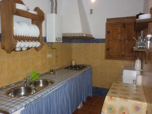 a kitchen with a sink and a counter top at Alojamiento Rural LA TEJA in Cortes de Baza