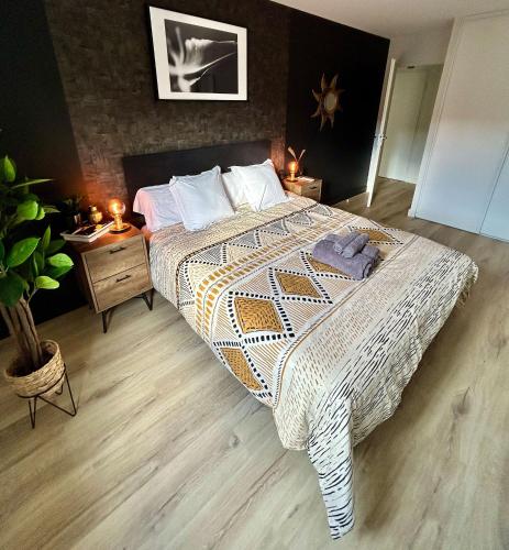 a bedroom with a large bed and two night stands at Modern 1 Bdr + Balcony + Free Parking + AC + Pool in LʼIsle-dʼAbeau
