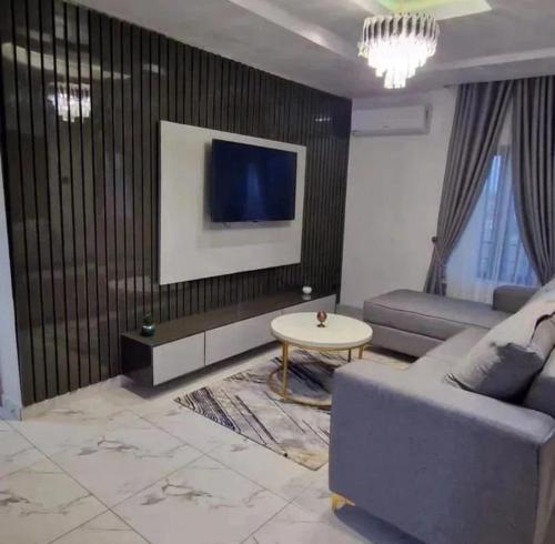 a living room with a couch and a table at Supreme Apartments in Ibadan