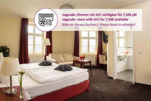 a hotel room with a bed and a couch at SchlafGut AppartementHotel in Leipzig