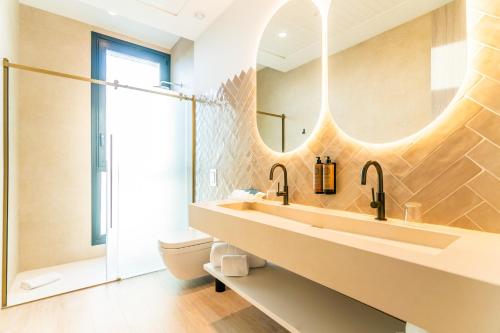 a bathroom with a sink and a mirror at Hotel Málaga Vibes in Málaga
