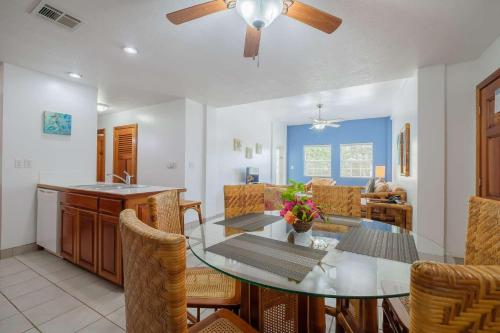 a dining room and kitchen with a table and chairs at Best Western Grand Baymen Gardens in San Pedro