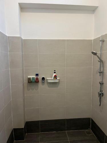 a bathroom with a shower with a sink and a shower at Khisya homestay in Kampong Soi