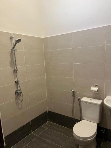 a bathroom with a toilet and a sink at Khisya homestay in Kampong Soi