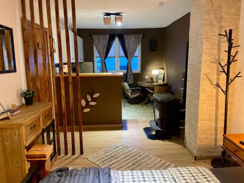 a room with a bed and a dining room with a table at Guest House Durmitor Paradise in Žabljak