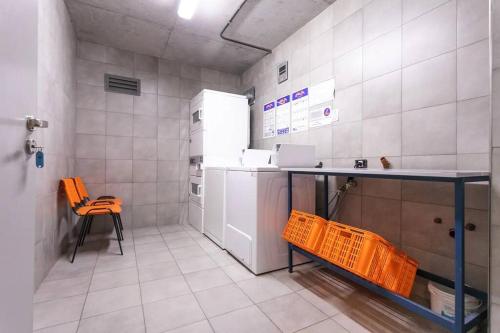 a kitchen with a counter and a table and a refrigerator at Apart de categoría con amenities y estacionamiento in Buenos Aires