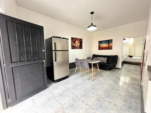 a living room with a refrigerator and a table at Acogedor Apartamento En La Circunvalar By Parceros Group in Pereira