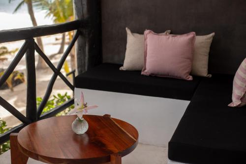 a room with a table and a couch and a table sidx sidx sidx at Casa Gitano in Tulum