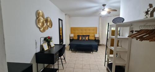 a room with a bedroom with a bed and a table at Le Madina in Pamandzi