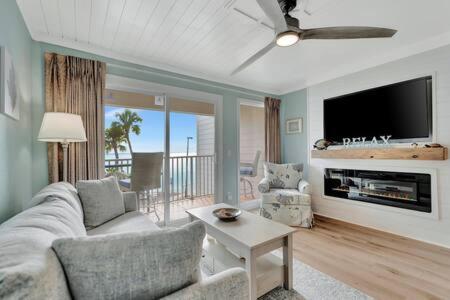 a living room with a couch and a tv at Oceans Pointe Nantucket inspired condo on the bay in Tampa