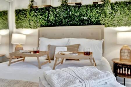 a bedroom with a bed and a table with drinks on it at The Hemingway subtropical luxury on the Tampa Bay in Tampa