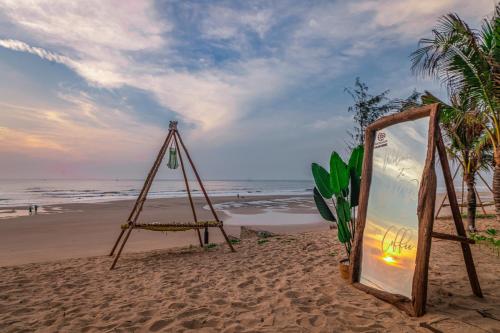 a sign in the sand on a beach at Long Hải Channel Beach Resort in Long Hai