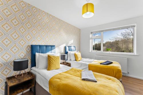 a bedroom with two beds and a window at Stylish Nottingham House - Parking - Garden in Nottingham