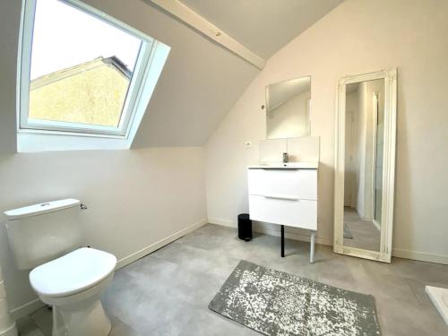 uma casa de banho com um WC, um lavatório e uma janela em Appartement 2chambres/PuyDuFou em Mauléon