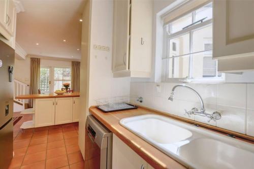 a kitchen with a sink and a window at Sunbird Cottage - Wilderness in Wilderness