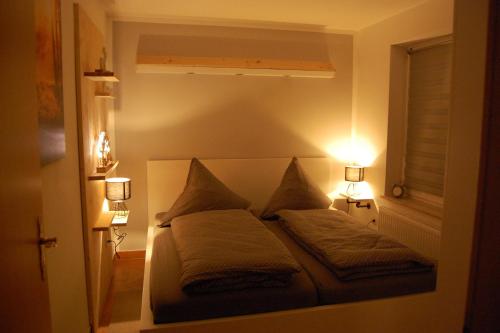 a bedroom with a bed with two pillows on it at Ferienwohnung Pörschke in Pobershau