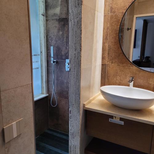 a bathroom with a sink and a shower at Palazzo Ferrucci Luxury Suites in Cagliari