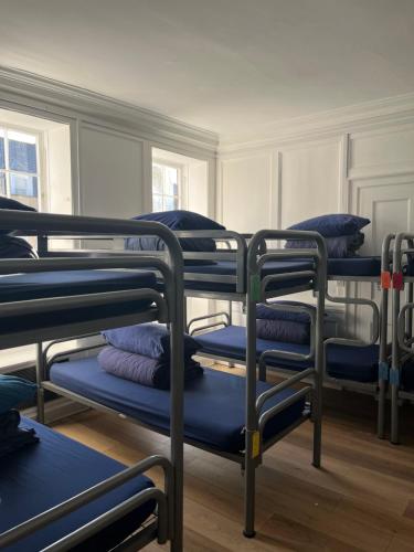 a group of bunk beds in a room at Bath Backpackers in Bath