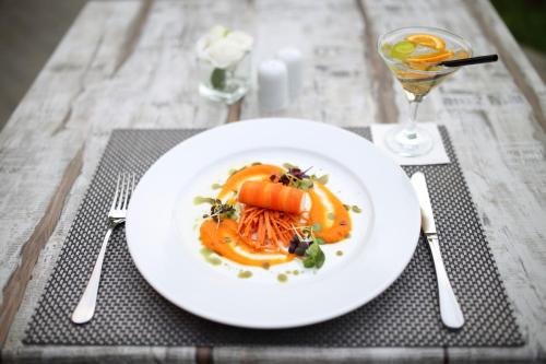 a plate of food on a table with a drink at Best Western Plus Lakeside Hotel in Székesfehérvár