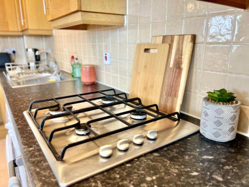 a stove top oven sitting on top of a kitchen counter at This weekend! Two double rooms with parking in quiet well-kept flat in Hatfield