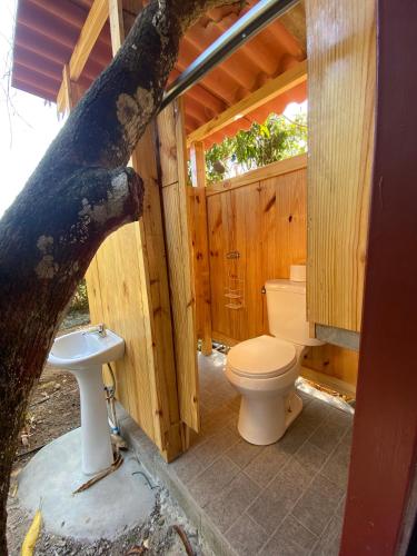 a bathroom with a toilet and a sink in a cabin at A Piece of Paradise in San Carlos