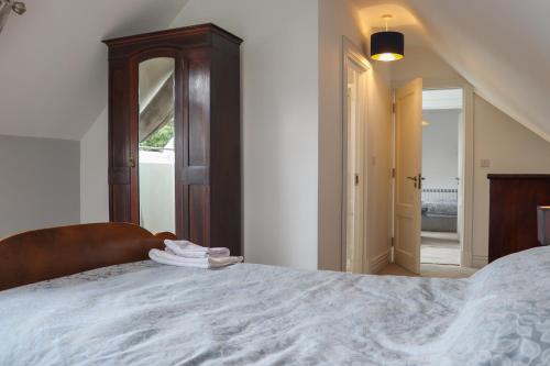 a bedroom with a large bed with a wooden headboard at Lakeview Retreat in Portroe