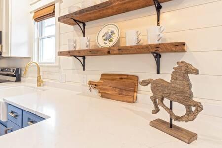a kitchen with a wooden horse on the wall at Downtown Luxury Farmhouse Apartment #3 in West Dundee