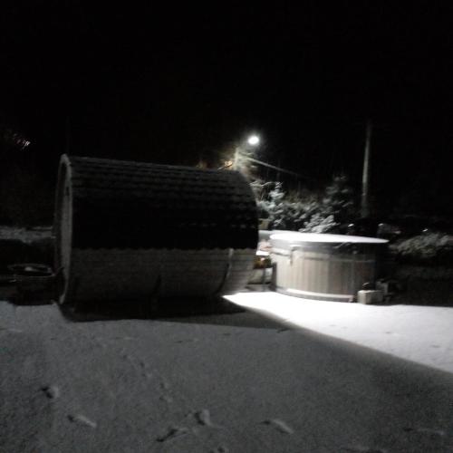 a black and white photo of a building at night at Pensiunea Roua Muntelui in Brăzeşti