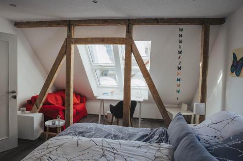 a bedroom with a bed and a desk in a room at Ferienwohnung Wunderbar in Bad Wildbad