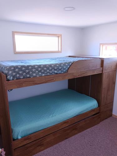 a couple of bunk beds in a room at Entre Pinos y Volcanes in Frutillar