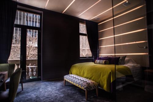 a bedroom with a yellow bed and a window at The Hip Hotel Santiago in Santiago