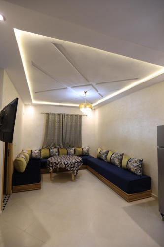 a living room with a couch and a tv at مولاي يعقوب in Fès