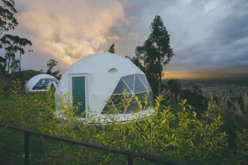 two white domes on top of a hill at NaturHotel in Cuenca