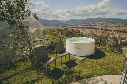 two chairs and a bath tub on top of a city at NaturHotel in Cuenca