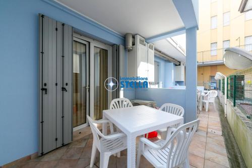 a white table and chairs on a balcony at Residence Adriatica in Lido di Jesolo