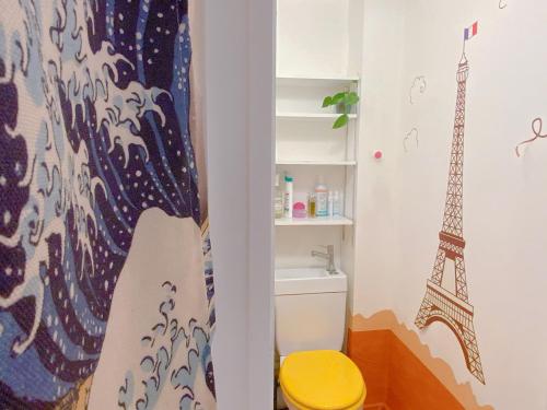a bathroom with a toilet and the eiffel tower at Enjoy Eiffel Tower Views from Home, Only 20 Minutes to Paris Center in Colombes
