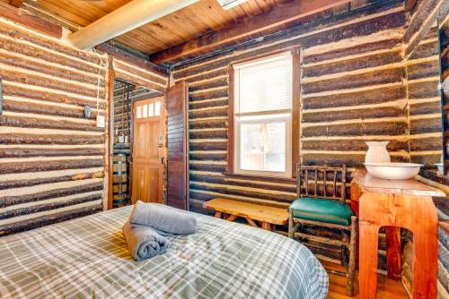 a bedroom with a bed and a wooden wall at Easy Interstate Access Original Poconos Log Cabin in Blakeslee