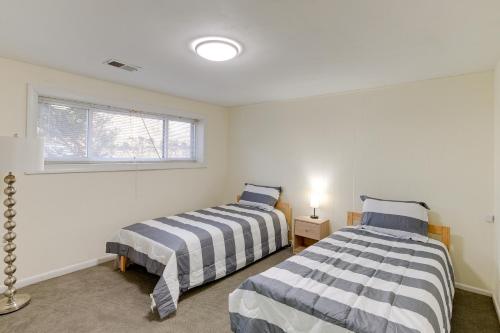 A bed or beds in a room at Lorton Vacation Rental Home with Backyard and Deck!