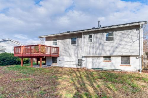 a house with a deck on the side of it at Backyard and Deck Family-Friendly Lorton Home! in Lorton
