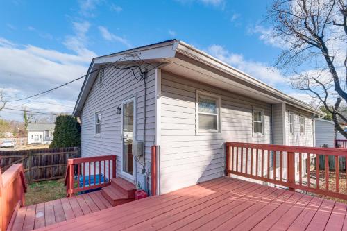 a small white house with a wooden deck at Backyard and Deck Family-Friendly Lorton Home! in Lorton