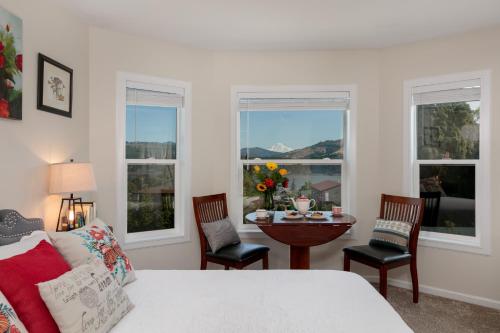 a bedroom with a bed and a table with chairs at The Irish Inn in Hood River