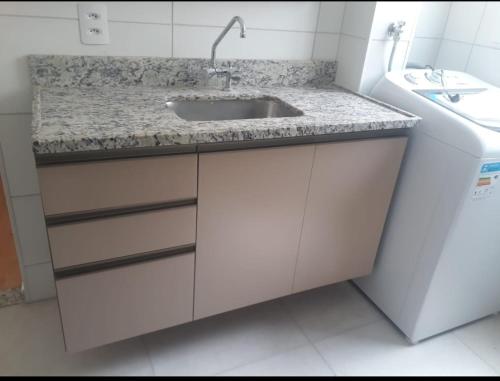 um banheiro com pia e bancada em Residencial Jardim da Costa com 2 quartos a 4 km praia em João Pessoa