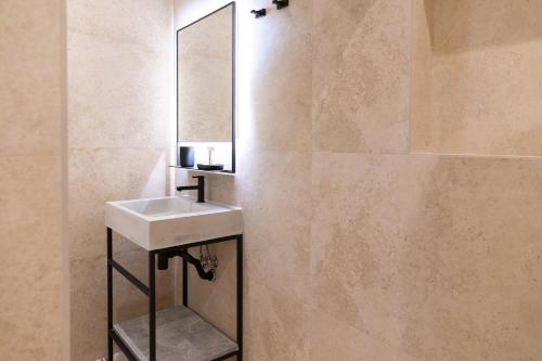 a bathroom with a sink and a mirror at Florette Suite Designer Finish with Stunning Lounge Terrace by ArcoBnb in Il-Furjana