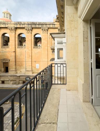 a view of a building from a balcony at Florette Suite Designer Finish with Stunning Lounge Terrace by ArcoBnb in Il-Furjana