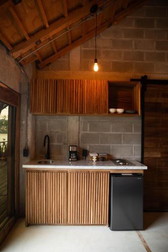 a kitchen with a black refrigerator and a sink at Tokipa at Punta Sayulita in Sayulita