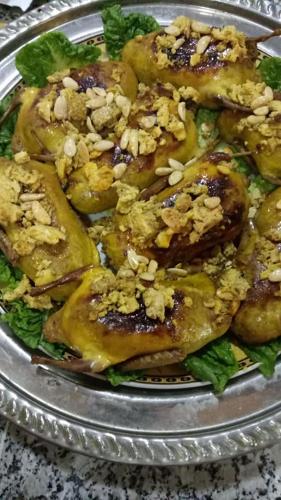 a plate of food with food on top of lettuce at El Menzeh Foundation in Rissani