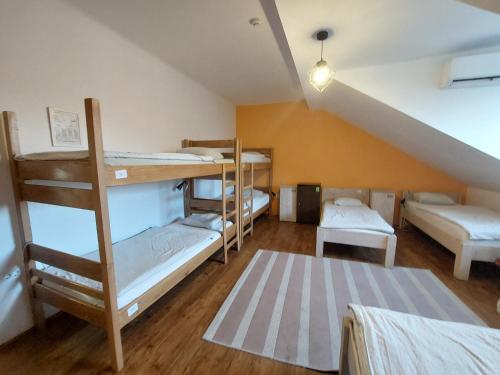 a room with three bunk beds in a attic at VV way - Lisica zvitorepka in Ljubljana