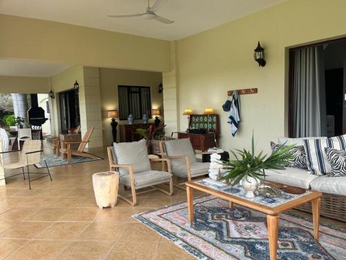 a living room with a couch and chairs and a table at Goedehoop Boutique Manor House in Malelane